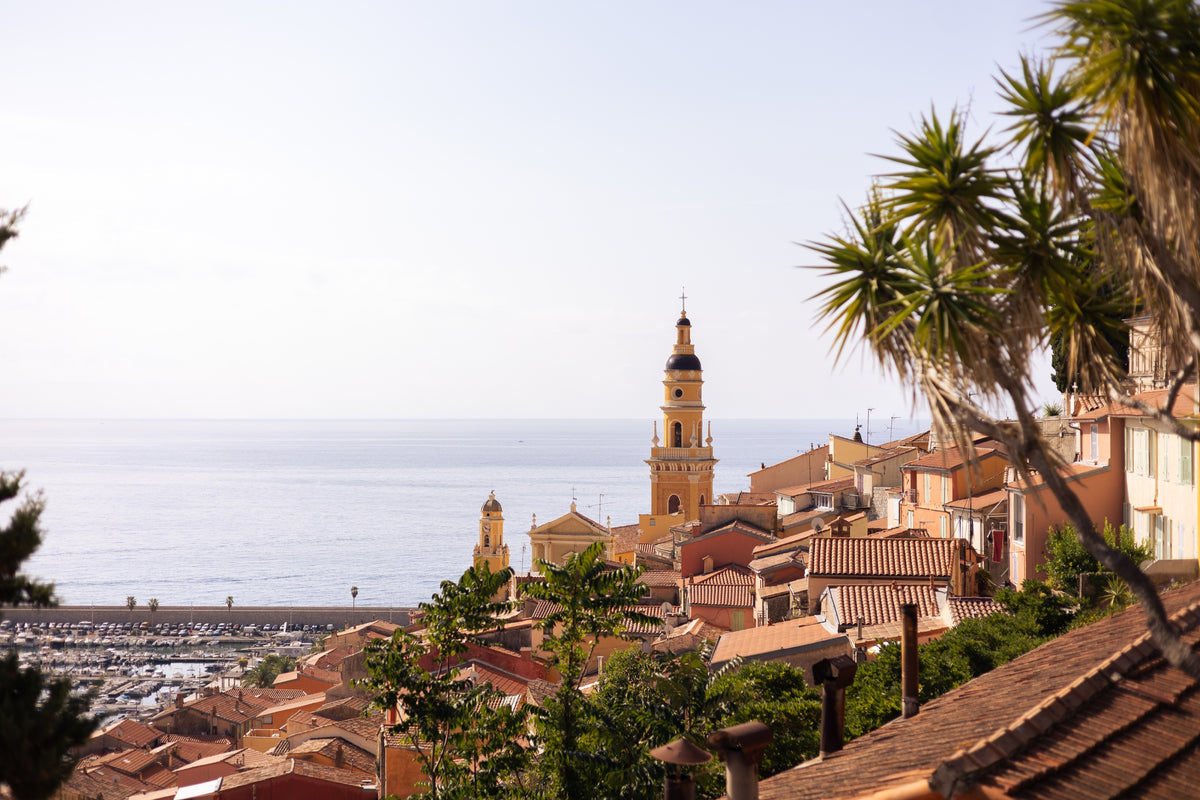 A sunlit Mediterranean town overlooking the sea